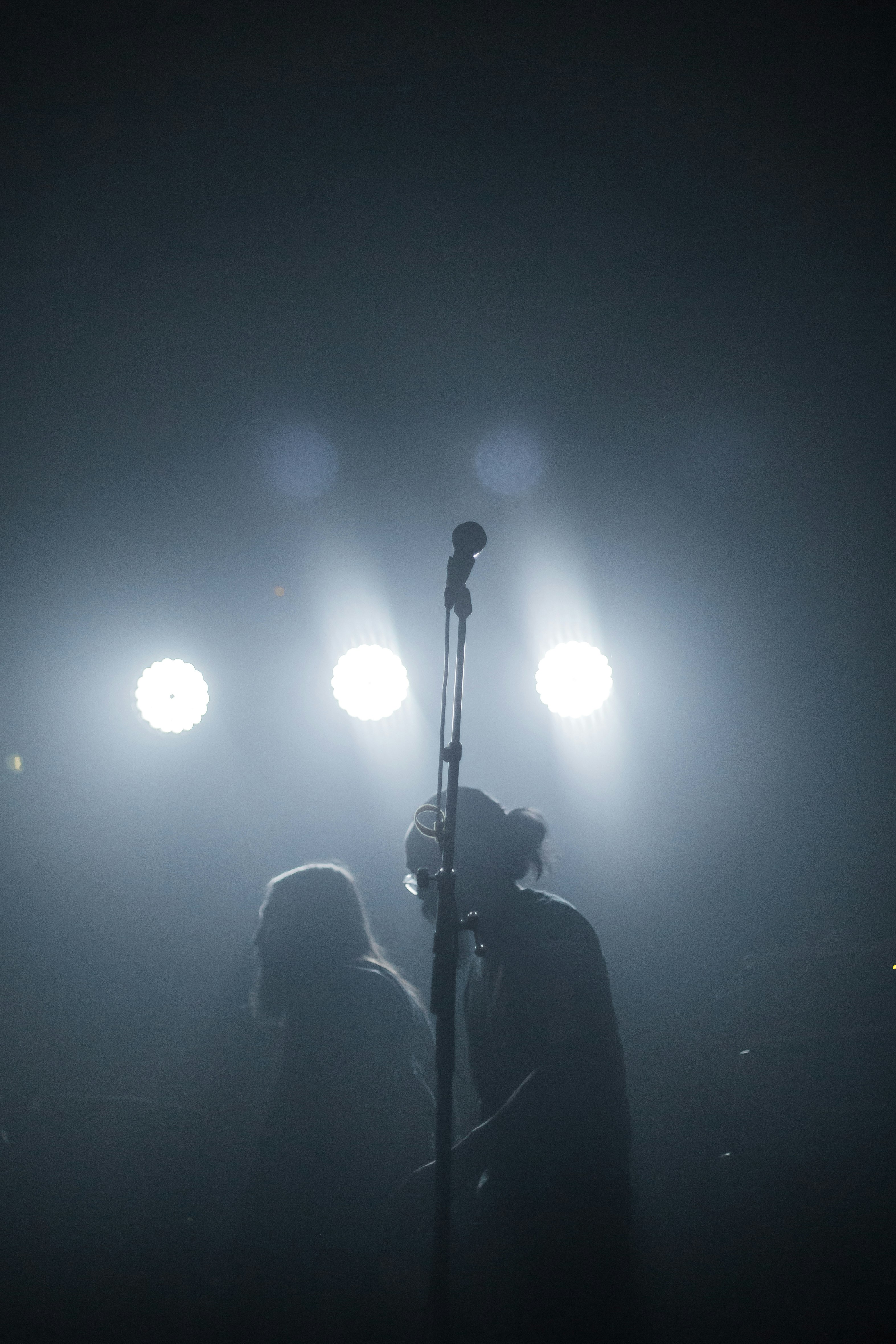 bokeh photography of two men performing on stage